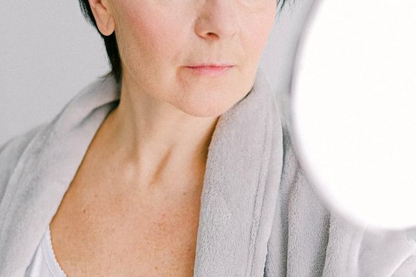 Person moving gracefully in a well-lit, minimalist space.